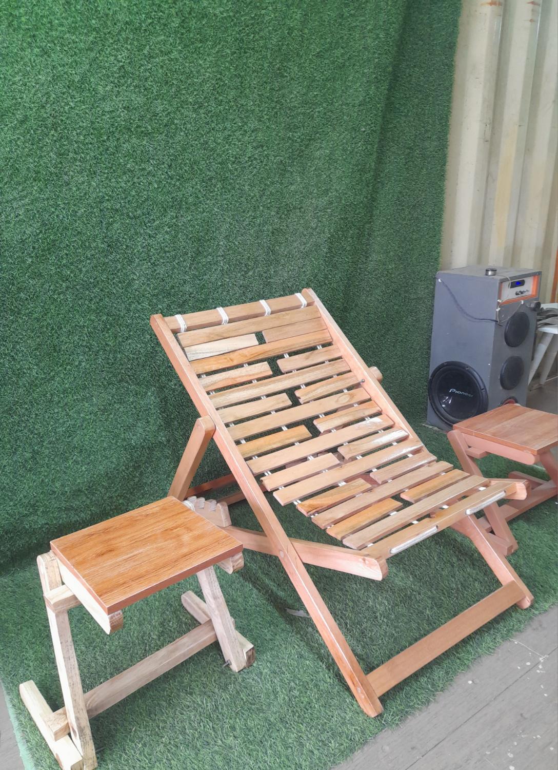 Hardwood lounge chairs set on a lawn